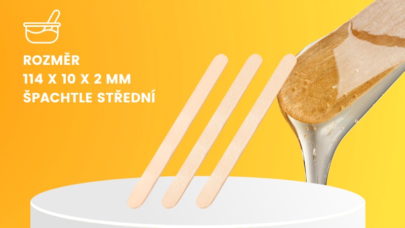 Střední velikost špachtle na depilaci, dřevěná na žlutém podkladu. 